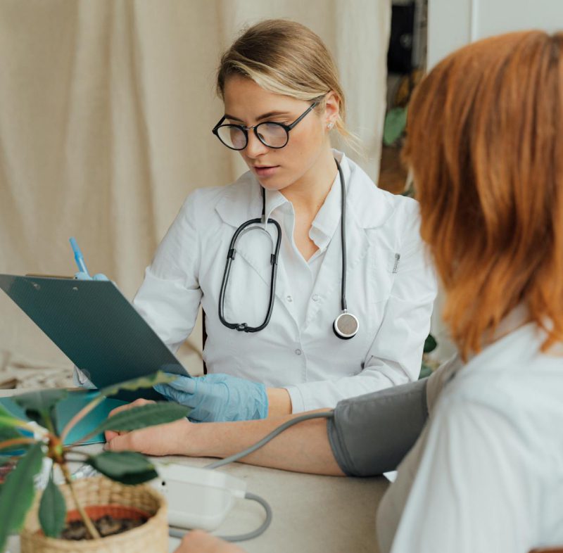 Doctor checking blood pressure